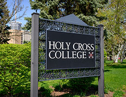 Photo of the Holy Cross College sign. Links to Gifts by Will