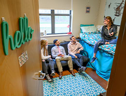 Photo of students in a dorm room. Links to What to Give